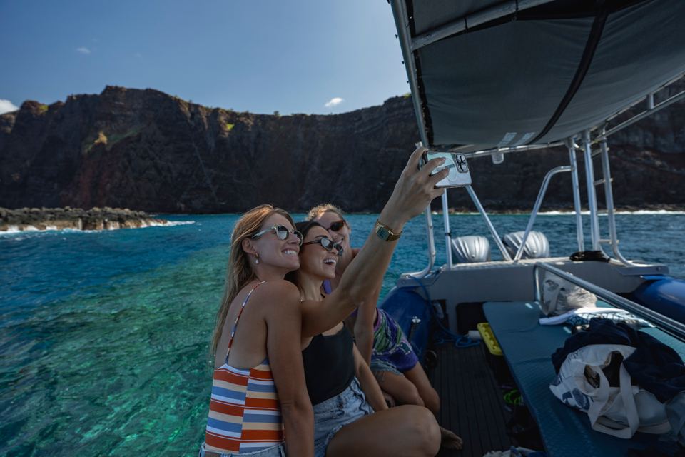 Guests on the raft beneath the sea cliffs of Lānaʻi